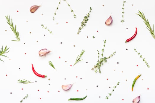 Flat lay overhead top view of greens herbs and spices on white background with copy space. Menu frame design food pattern background with cooking ingredients