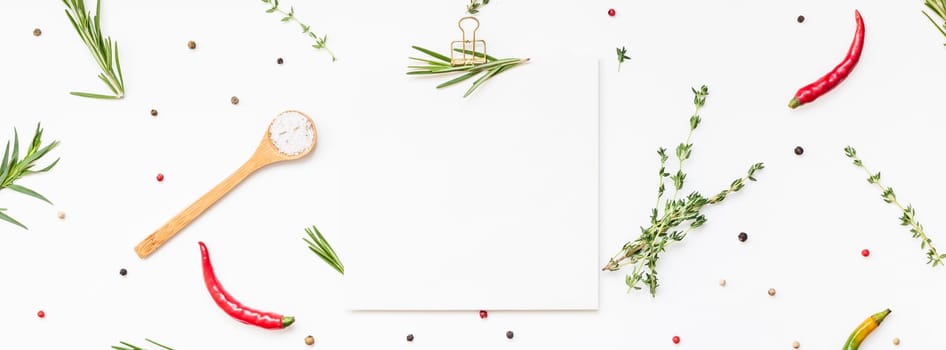 Flat lay overhead view blank recipe paper page with clip mockup text space invitation card on white background with greens herbs and spices. Menu recipe book food blog design with cooking ingredients