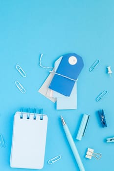 Top view flat lay of workspace desk styled design school and office supplies with copy space turquoise blue color paper background minimal style. Template for feminine blog social media