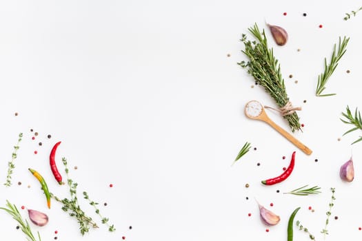 Flat lay overhead top view of greens herbs and spices on white background with copy space. Menu frame design food pattern background with cooking ingredients