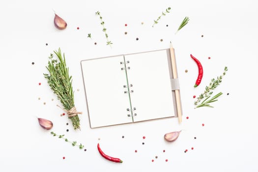 Flat lay overhead view blank notebook pages mockup text space invitation card on white background with greens herbs and spices. Menu or recipe book or food blog design with cooking ingredients