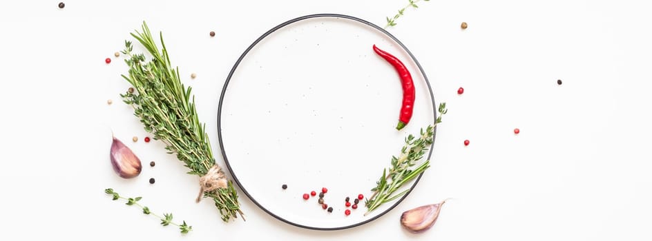 Flat lay overhead view empty plate mockup blank text space invitation card on white background with greens herbs and spices. Menu design food background with cooking ingredients