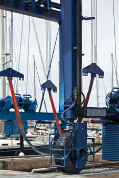 Big crane for a ship maintenance in a marina. Vertical shot