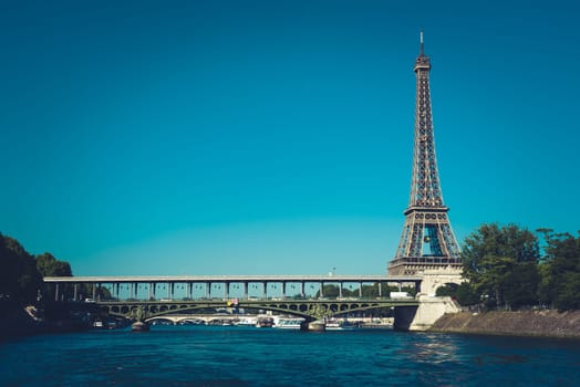 The Eiffel tower and the Seine river with blue clear sky in background Paris France