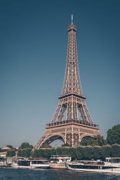 The Eiffel tower and the Seine river with blue clear sky in background Paris France