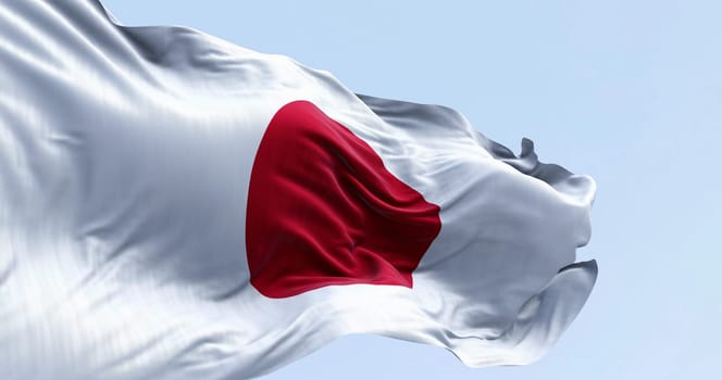 Japan national flag waving in the wind on a clear day. Red disc on a white field. Japan is an island country in East Asia. 3D illustration render. Rippled textile. Selective focus. Waving flag