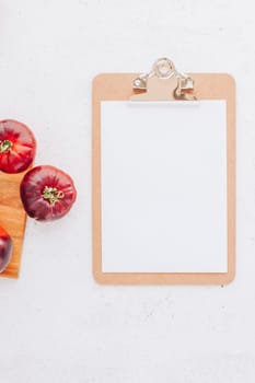Creative flat lay top view mockup of exotic spanish made tomatoes Mar Azul on white wooden table background copy space. Minimal house cooking concept mock up for blog or recipe book