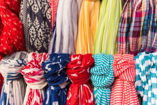 Selection of colorful women scarves at a market