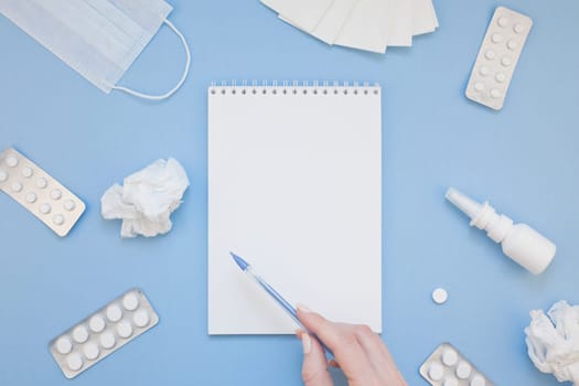 Creative flat lay concept of seasonal spring allergy with napkins, pills, face mask, drops in a bottle and a female hand with copy space background minimal style, template for text
