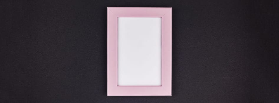 Mock up of a millennial pink frame on dark black color paper background with copy space in minimal style, template for text or your image mockup. Long wide banner
