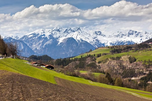 Spring in Tirol Alps. Landscape with meadows and mountains