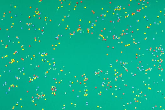 New Year or Christmas pattern 2020 flat lay top view Xmas holiday celebration green paper colorful confetti background. Template for greeting card your text design