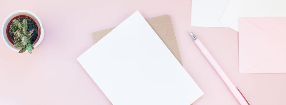 Long wide banner of workspace desk styled design office supplies and cactuses succulents with copy space millennial pink color paper background minimal style. Template for feminine blog social media