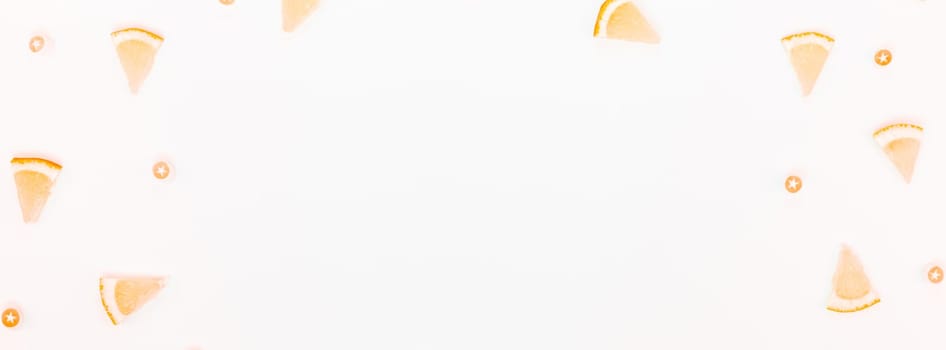 Long wide banner top view citrus lemon slices pattern frame white table background with copyspace. Hot summer refreshment lemonade concept. Beverage ingredients arranged