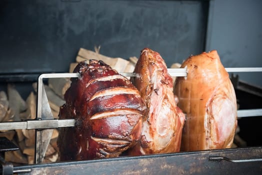 roasted pig knuckles on the spit for a big company