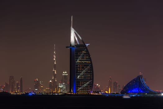 UAE, DUBAI - DECEMBER 26: Night cityscape of Dubai city with Burj Al Arab Jumeirah building on the front, United Arab Emirates on December 26, 2014