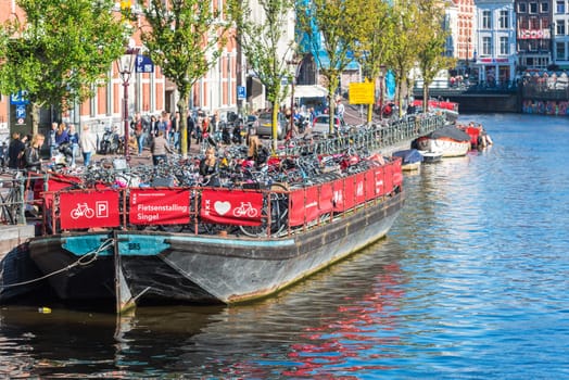 NETHERLANDS, AMSTERDAM - OCTOBER 2: bicycle parking on an old tour boat in Amsterdam on October 2, 2015