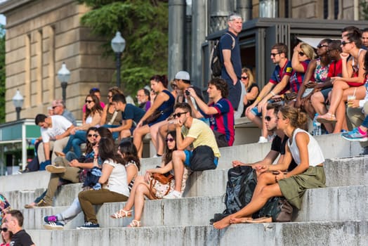 SPAIN, BARCELONA - SEPTEMBER 13: Crowd of tourists sit on the National Palace stairs on September 13, 2015