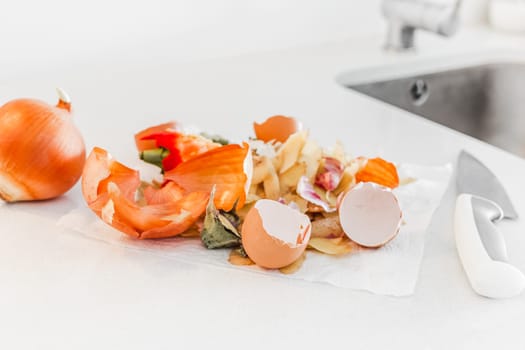 Organic home cooking food waste ready to compost. Ecological concept. Food leftovers, Vegetable Peelings on kitchen table. Environmentally responsible behavior, waste management, recycling garbage.