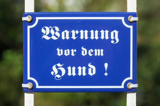 Dog warning sign, Biting dog on a garden fence, Germany