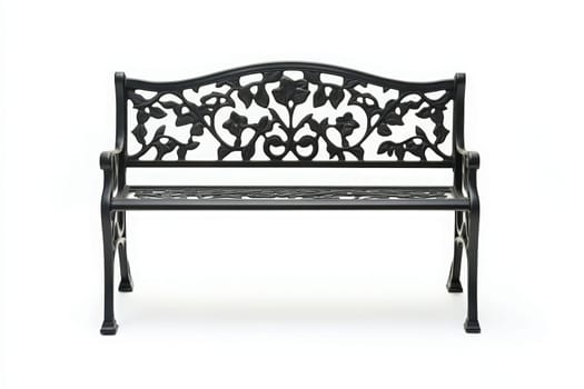 A stylish black garden bench, featuring intricate floral patterns, stands alone in a minimalist setting, inviting relaxation and contemplation in an outdoor space.