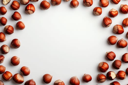 A collection of hazelnuts is arranged in a circular formation on a subtle light background.