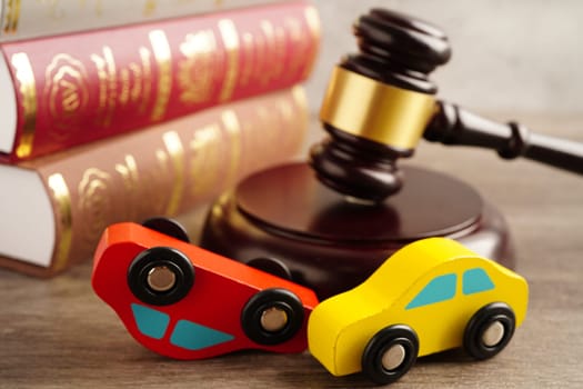 Car accident lawsuit and insurance, Judge hammer with car model.