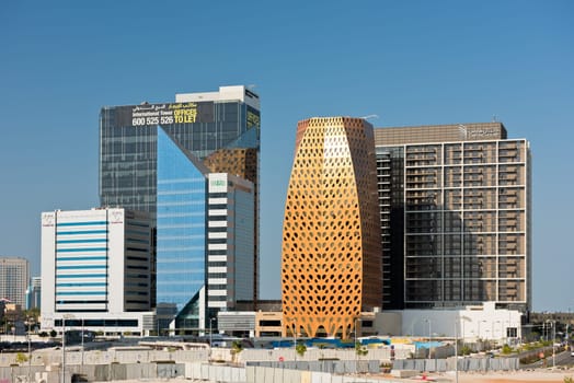 ABU DHABI, UAE - DECEMBER 22: tall buildings under construction against a blue sky in Abu Dhabi on December 22, 2014. United Arab Emirates