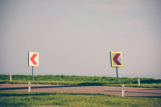 Road signs warning drivers about ahead dangerous curve