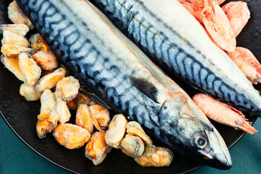 Whole raw organic fish mackerel with ingredients for cooking. Top view.