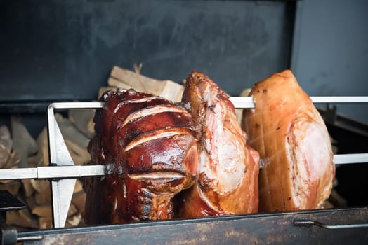 roasted pig knuckles on the spit for a big company