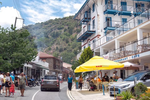 Pedoulas, Limassol District, Cyprus - June 11, 2023: Tourists walking on the street of Pedoulas village, visiting shops and restaurants on a sunny day
