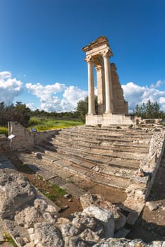 Sanctuary of apollo hylates showing restored columns on a sunny day with blue sky and white clouds, in cyprus