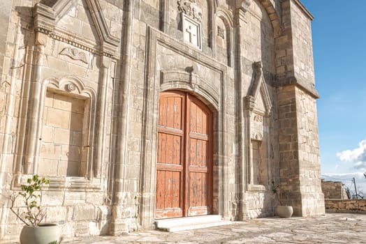 The Timios Prodromos church in Vouni village features beautiful stonework and a large wooden door. Limassol District, Cyprus