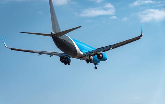 Large passenger airplane is approaching an airport runway, preparing for landing