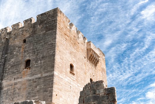 Kolossi castle with its dominating presence standing tall against a bright blue sky with clouds. Limassol District, Cyprus