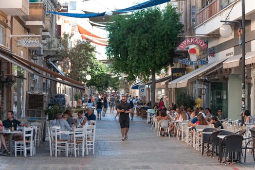 Nicosia, Cyprus - October 24, 2022: Crowded street in Nicosia, Cyprus with people enjoying lunch and drinks outdoors