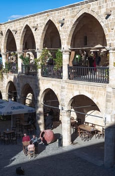 Nicosia, Cyprus - March 12, 2015: Tourists visiting Buyuk Han, the largest caravanserai of Nicosia city, Cyprus