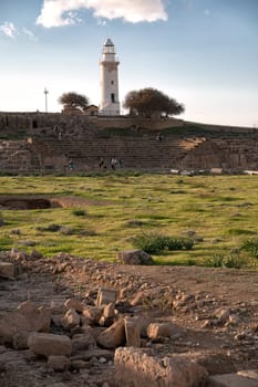 Tourists walking around Paphos lighthouse at archaeological site. Cyprus