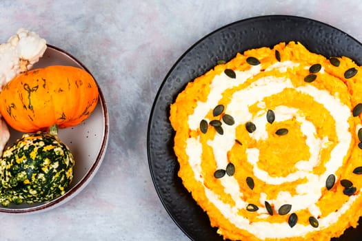 Autumn pumpkin risotto with parmesan cheese on wooden rustic background.