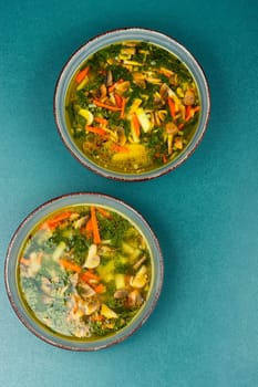 Diet vegetable soup made from fresh spinach and wild mushrooms.