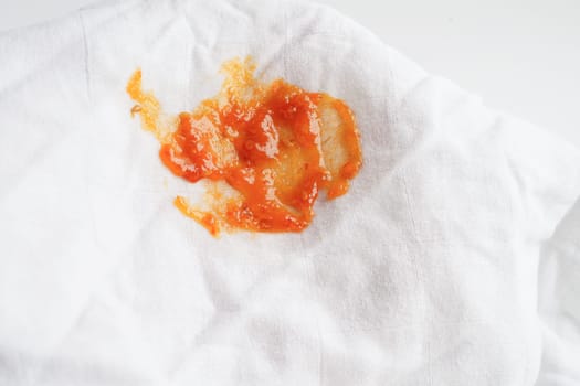 Dirty tomato sauce stain or ketchup on cloth to wash with washing powder, cleaning housework concept.