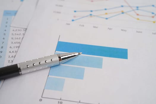 Pen on chart graph paper. Finance, account, statistic, investment data economy, stock exchange business.