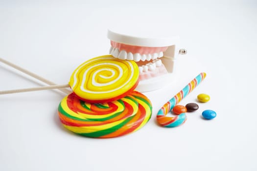 Tooth decay with sweet sugar candy, bad food for dental health care.