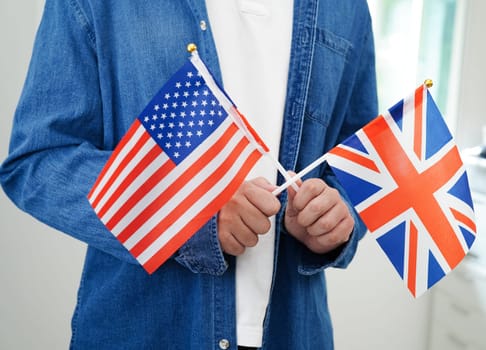 Learning English, Asian teenage student holding flag for language program education.