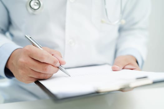Asian man doctor study document to research method and technic for treating patients.
