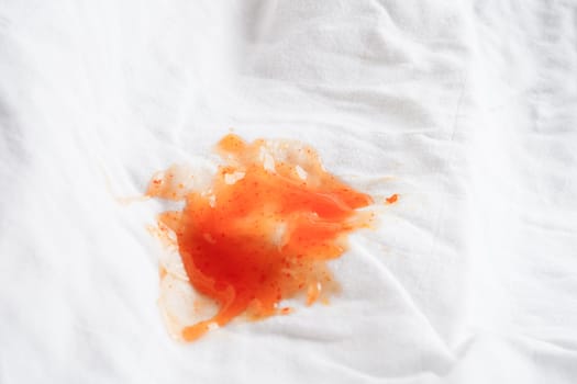 Dirty tomato sauce stain or ketchup on cloth to wash with washing powder, cleaning housework concept.
