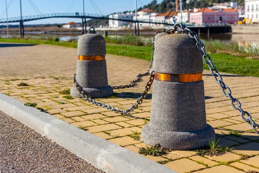 Stub posts linked in a chain on a quay in a small Portugal town
