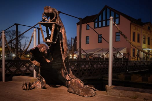 City attraction - statue in old port of Klaipeda, Lithuania. Legend of black no-face ghost with a lantern in gnarled hand come out of harbor waters.