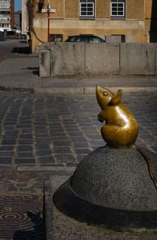 City attraction of tiny mouse street statue in old part of Klaipeda, Lithuania. City symbols, medieval towns, sunny day, cobbled pavement.